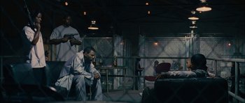 Movie still from “Waist Deep” (2006), directed by Vondie Curtis-Hall – A group of people sitting in a room; Wide shot, Over the shoulder angle