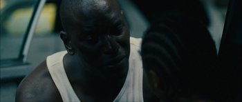 Movie still from “Waist Deep” (2006), directed by Vondie Curtis-Hall – A man's face in a dark room; Close Up shot, Over the shoulder angle