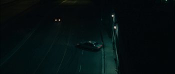 Movie still from “Waist Deep” (2006), directed by Vondie Curtis-Hall – A car driving down a street at night with headlights on; Extreme Wide shot, High angle