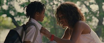 Movie still from “Waist Deep” (2006), directed by Vondie Curtis-Hall – A woman helping a boy put on a tie; Close Up shot, Over the shoulder angle