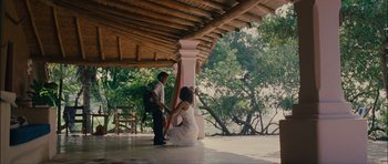 Movie still from “Waist Deep” (2006), directed by Vondie Curtis-Hall – A man kneeling down next to a woman in a white dress; Extreme Wide shot, Over the shoulder angle