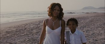 Movie still from “Waist Deep” (2006), directed by Vondie Curtis-Hall – A woman and a child walking on the beach; Medium shot, Over the shoulder angle