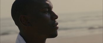 Movie still from “Waist Deep” (2006), directed by Vondie Curtis-Hall – A man's face in the sunlight; Close Up shot, Low angle
