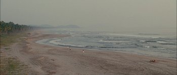 Movie still from “Waist Deep” (2006), directed by Vondie Curtis-Hall – People are walking on the beach near the water; Extreme Wide shot, High angle