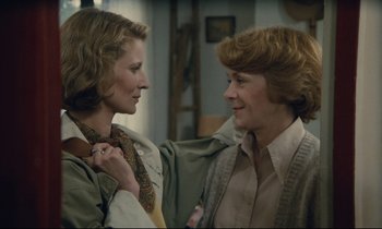 Movie still from “Waiter!” (1983), directed by Claude Sautet – Two women standing next to each other in a room; Close Up shot, Over the shoulder angle