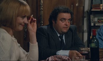 Movie still from “Waiter!” (1983), directed by Claude Sautet – A man and a woman sitting at a dinner table; Close Up shot, High angle