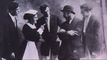 Movie still from “Waiting for Guffman” (1996), directed by Christopher Guest – A group of people standing next to each other; Medium shot, Low angle