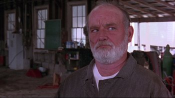 Movie still from “Waiting for Guffman” (1996), directed by Christopher Guest – An older man with a beard is looking at the camera; Close Up shot, Over the shoulder angle