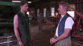 Movie still from “Waiting for Guffman” (1996), directed by Christopher Guest – Two men are standing in a room talking to each other; Medium shot, Over the shoulder angle
