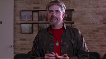 Movie still from “Waiting for Guffman” (1996), directed by Christopher Guest – A man in a red shirt and a brown jacket; Medium shot, Low angle