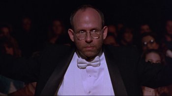 Movie still from “Waiting for Guffman” (1996), directed by Christopher Guest – A man wearing a bow tie and a tuxedo; Close Up shot, Low angle