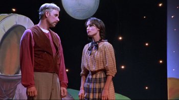 Movie still from “Waiting for Guffman” (1996), directed by Christopher Guest – A man and a woman standing next to each other on a stage; Medium shot, Over the shoulder angle