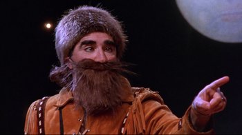Movie still from “Waiting for Guffman” (1996), directed by Christopher Guest – A man with a long beard and a fur hat; Close Up shot, Low angle
