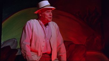 Movie still from “Waiting for Guffman” (1996), directed by Christopher Guest – An older man wearing a white hat and holding an umbrella; Medium shot, Low angle