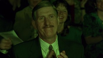 Movie still from “Waiting for Guffman” (1996), directed by Christopher Guest – A person wearing a suit and tie; Close Up shot, Low angle