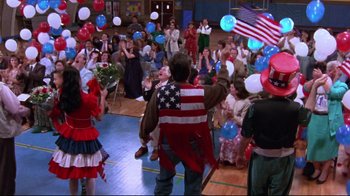 Movie still from “Waiting for Guffman” (1996), directed by Christopher Guest – A group of people in a room with balloons; Wide shot, High angle
