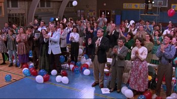 Movie still from “Waiting for Guffman” (1996), directed by Christopher Guest – A group of people standing in front of balloons; Wide shot, High angle