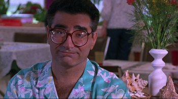 Movie still from “Waiting for Guffman” (1996), directed by Christopher Guest – A person wearing glasses and a hawaiian shirt; Close Up shot, Over the shoulder angle