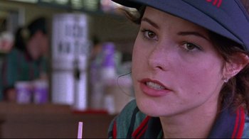 Movie still from “Waiting for Guffman” (1996), directed by Christopher Guest – A person wearing a hat and holding a drink; Close Up shot, Over the shoulder angle