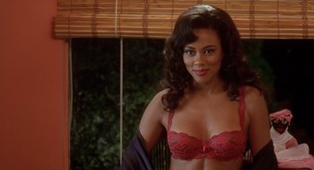 Movie still from “Waiting to Exhale” (1995), directed by Forest Whitaker – A woman in a red bra posing for a picture; Medium shot, High angle