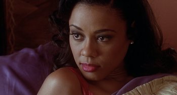 Movie still from “Waiting to Exhale” (1995), directed by Forest Whitaker – A woman's face in a red shirt; Close Up shot, High angle
