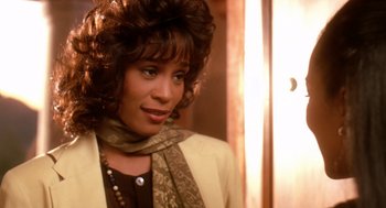 Movie still from “Waiting to Exhale” (1995), directed by Forest Whitaker – A person wearing a jacket and a scarf; Close Up shot, Over the shoulder angle