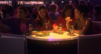 Movie still from “Waiting to Exhale” (1995), directed by Forest Whitaker – A group of people sitting at a table eating food; Medium shot, High angle
