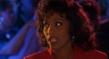 Movie still from “Waiting to Exhale” (1995), directed by Forest Whitaker – A person wearing a red shirt; Close Up shot, Over the shoulder angle