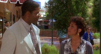 Movie still from “Waiting to Exhale” (1995), directed by Forest Whitaker – A man and a woman talking to each other outside; Medium shot, Over the shoulder angle