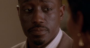 Movie still from “Waiting to Exhale” (1995), directed by Forest Whitaker – A person wearing a suit and tie; Close Up shot, High angle