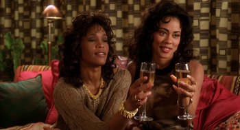 Movie still from “Waiting to Exhale” (1995), directed by Forest Whitaker – Two women sitting next to each other holding glasses of wine; Close Up shot, High angle