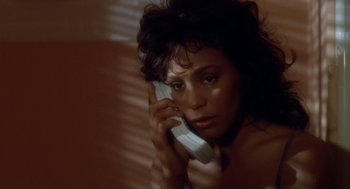 Movie still from “Waiting to Exhale” (1995), directed by Forest Whitaker – A woman holding a cell phone up to her ear; Close Up shot, High angle