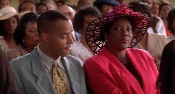 Movie still from “Waiting to Exhale” (1995), directed by Forest Whitaker – A man and a woman sitting next to each other; Close Up shot, Low angle