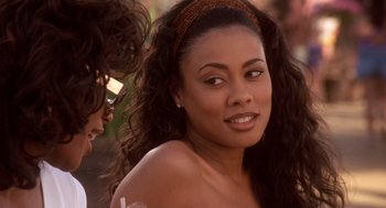 Movie still from “Waiting to Exhale” (1995), directed by Forest Whitaker – A beautiful young woman with long black curly hair; Close Up shot, Over the shoulder angle