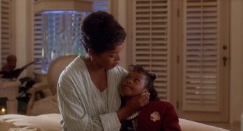 Movie still from “Waiting to Exhale” (1995), directed by Forest Whitaker – A woman and a young girl are looking at one another; Close Up shot, Over the shoulder angle
