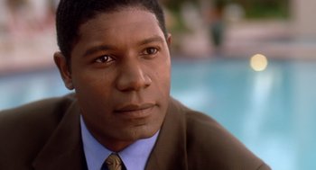 Movie still from “Waiting to Exhale” (1995), directed by Forest Whitaker – A person wearing a suit near a pool; Close Up shot, High angle