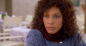 Movie still from “Waiting to Exhale” (1995), directed by Forest Whitaker – A person wearing a blue sweater; Close Up shot, High angle