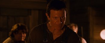Movie still from “Walk Hard: The Dewey Cox Story” (2007), directed by Jake Kasdan – A person wearing a brown shirt; Close Up shot, Over the shoulder angle