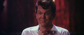 Movie still from “Walk Hard: The Dewey Cox Story” (2007), directed by Jake Kasdan – A person wearing a white shirt; Close Up shot, Low angle