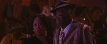 Movie still from “Walk Hard: The Dewey Cox Story” (2007), directed by Jake Kasdan – A man and a woman standing next to each other; Close Up shot, Over the shoulder angle