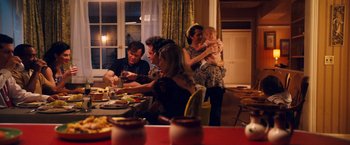 Movie still from “Walk Hard: The Dewey Cox Story” (2007), directed by Jake Kasdan – A group of people sitting around a table eating food; Medium shot, High angle