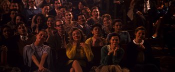 Movie still from “Walk Hard: The Dewey Cox Story” (2007), directed by Jake Kasdan – A group of people sitting in a room; Wide shot, High angle