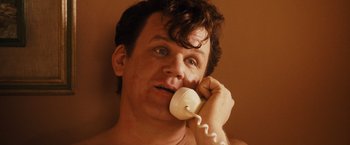 Movie still from “Walk Hard: The Dewey Cox Story” (2007), directed by Jake Kasdan – A person talking on a phone; Close Up shot, High angle