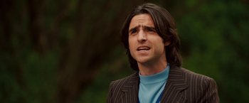 Movie still from “Walk Hard: The Dewey Cox Story” (2007), directed by Jake Kasdan – A person with long hair; Close Up shot, Over the shoulder angle
