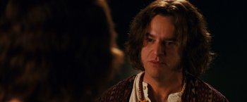 Movie still from “Walk Hard: The Dewey Cox Story” (2007), directed by Jake Kasdan – A person with long brown hair; Close Up shot, Over the shoulder angle