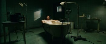 Movie still from “Walk Hard: The Dewey Cox Story” (2007), directed by Jake Kasdan – A man sitting in a bath tub in a bathroom; Wide shot, High angle