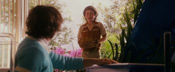 Movie still from “Walk Hard: The Dewey Cox Story” (2007), directed by Jake Kasdan – A young boy is standing in the grass; Medium shot, Over the shoulder angle