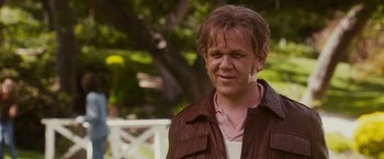 Movie still from “Walk Hard: The Dewey Cox Story” (2007), directed by Jake Kasdan – A person wearing a brown jacket; Close Up shot, Over the shoulder angle