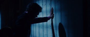 Movie still from “Walk Hard: The Dewey Cox Story” (2007), directed by Jake Kasdan – A man reaching his hand out to someone in a dark room; Medium shot, Low angle