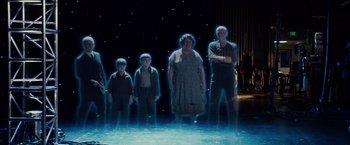 Movie still from “Walk Hard: The Dewey Cox Story” (2007), directed by Jake Kasdan – A group of people standing in front of a stage; Wide shot, High angle